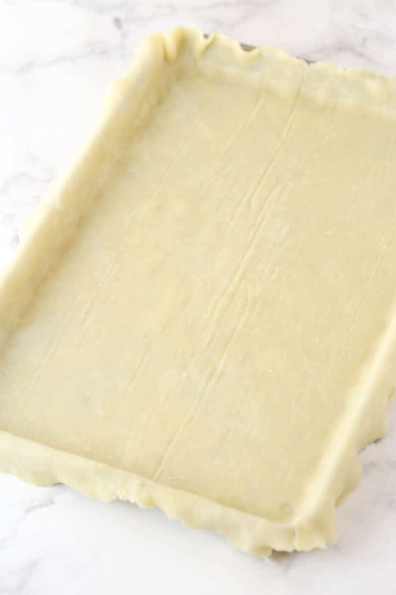 Pie dough fitted into a baking dish.