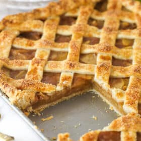 Apple slab pie with a slice taken out of it.