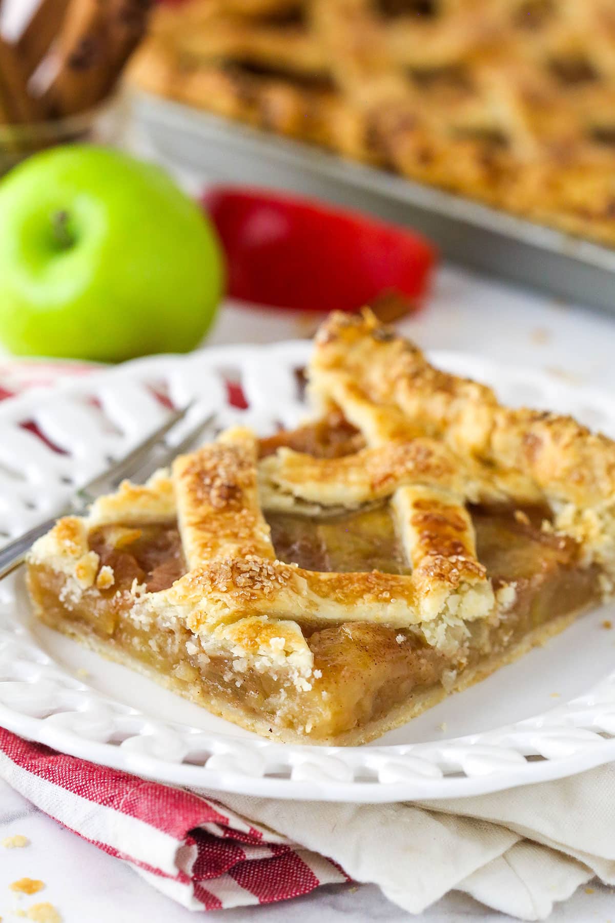 A slice of apple slab pie on a plate.