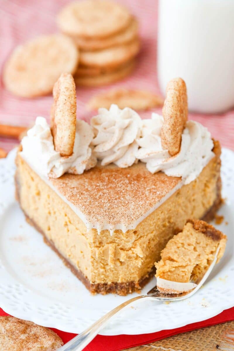 A slice of snickerdoodle dulce de leche cheesecake with a bite removed on a fork.