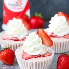 Three strawberry banana frozen yogurt cupcakes on a silver tray.