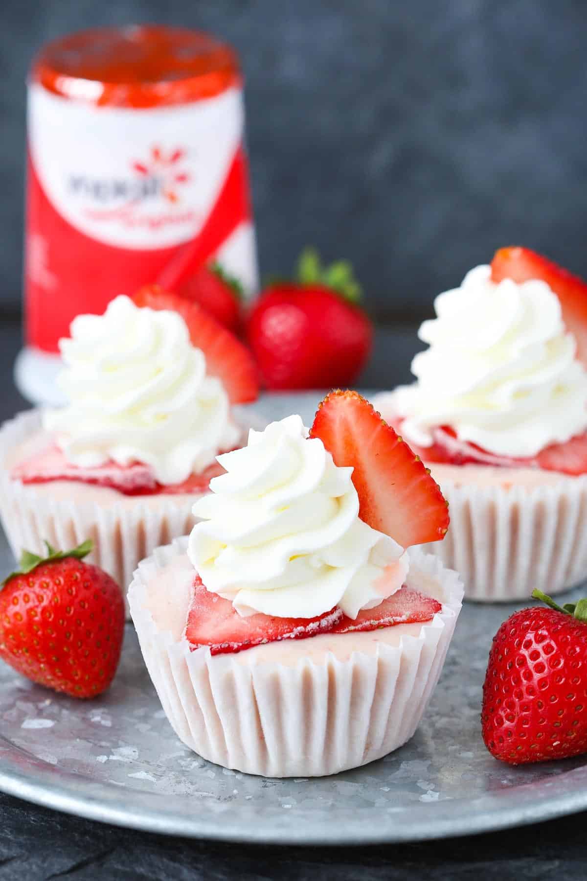 Three strawberry banana frozen yogurt cupcakes on a silver tray.