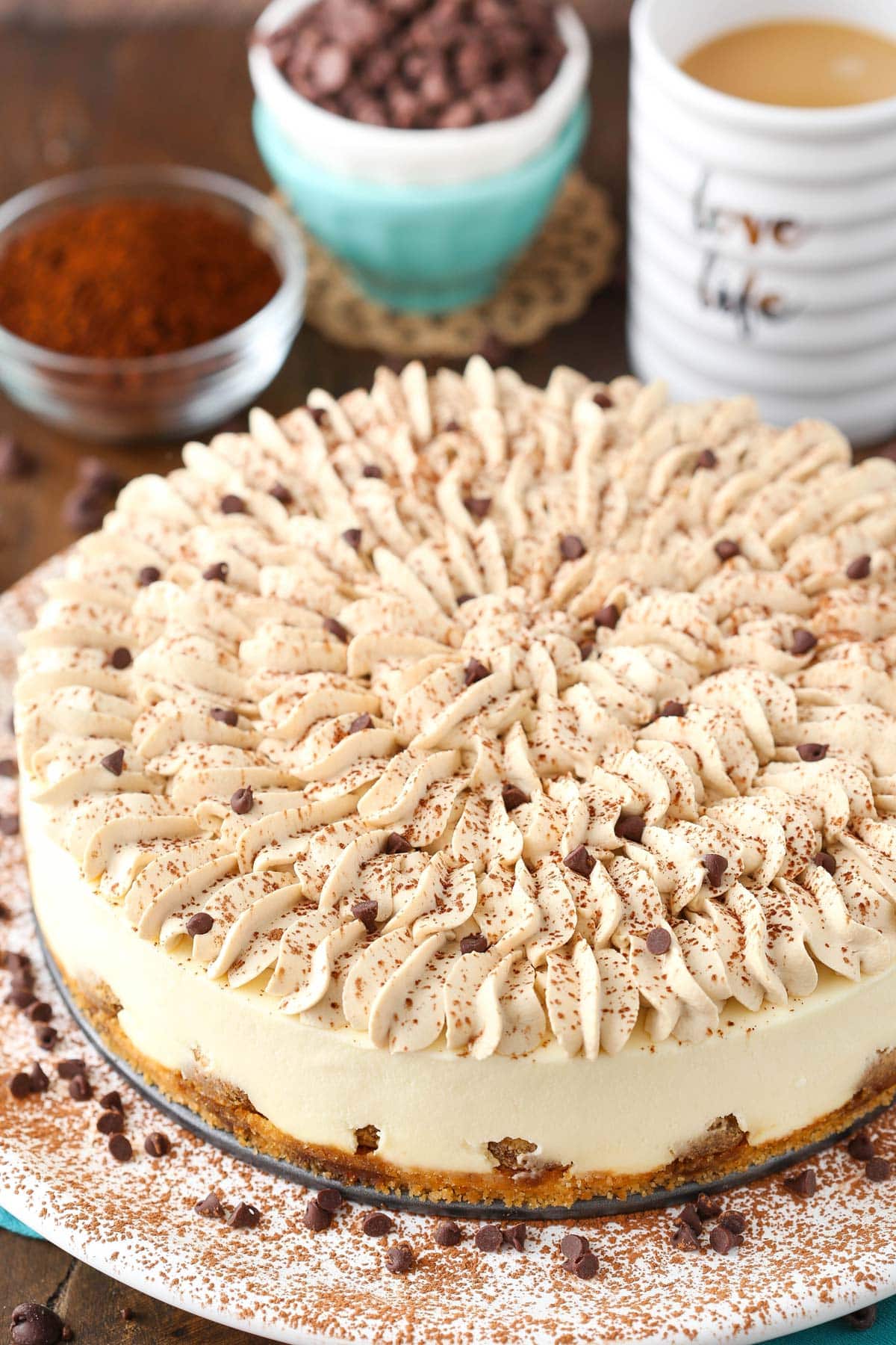 A tiramisu cheesecake on a large white plate.