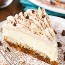 A slice of tiramisu cheesecake on a white plate.