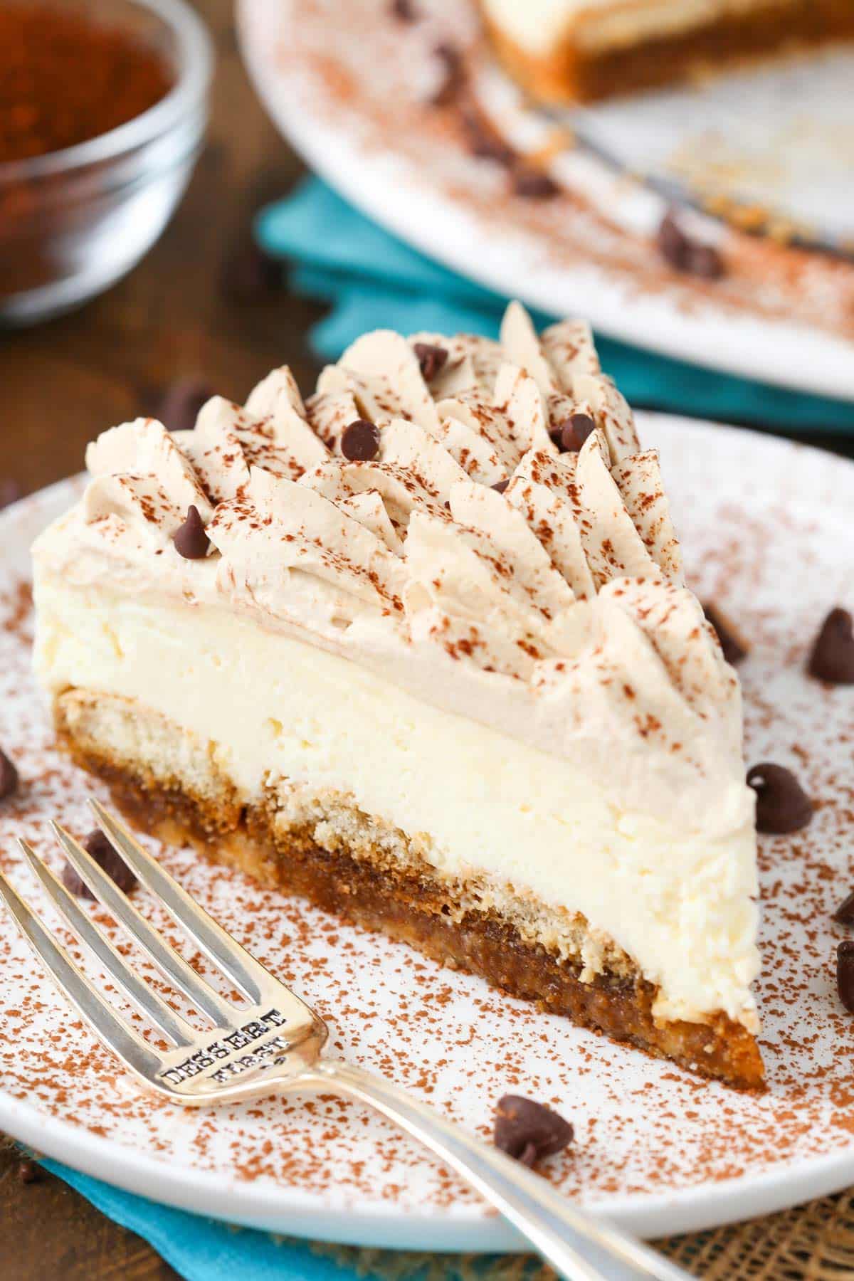A slice of tiramisu cheesecake on a white plate.