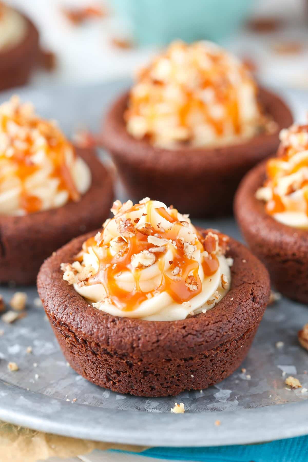 Close up of a turtle chocolate cookie cup on a silver tray.