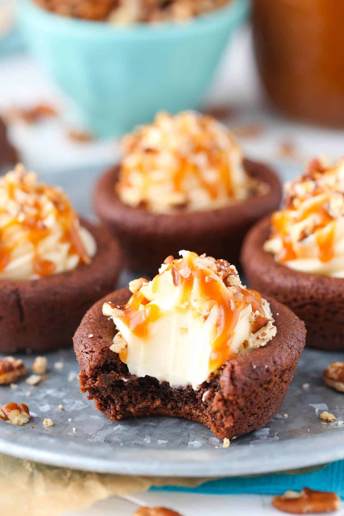 Close up of a turtle chocolate cookie cup with a bite out of it.