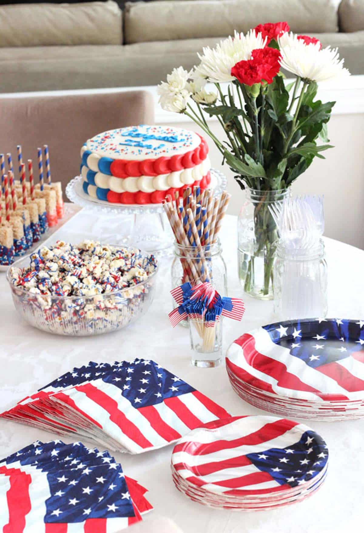 A table covered with patriotic napkins, plates, and food.
