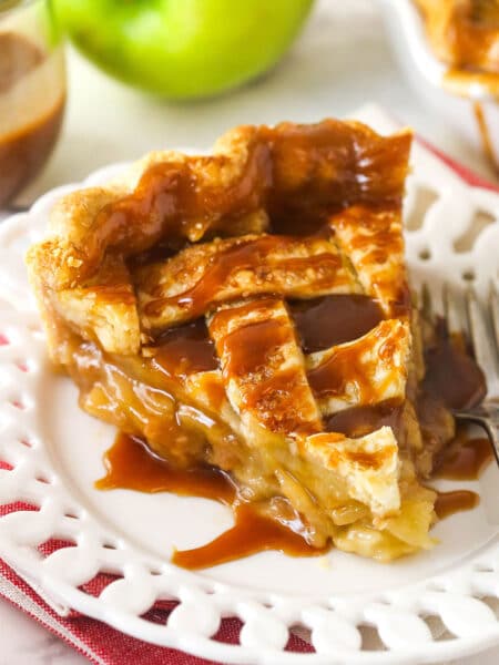 A large slice of caramel apple pie on a plate.