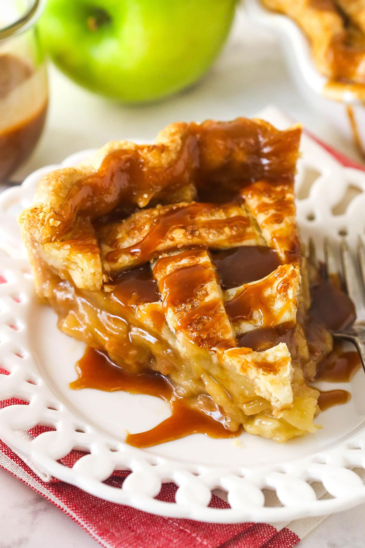 A large slice of caramel apple pie on a plate.