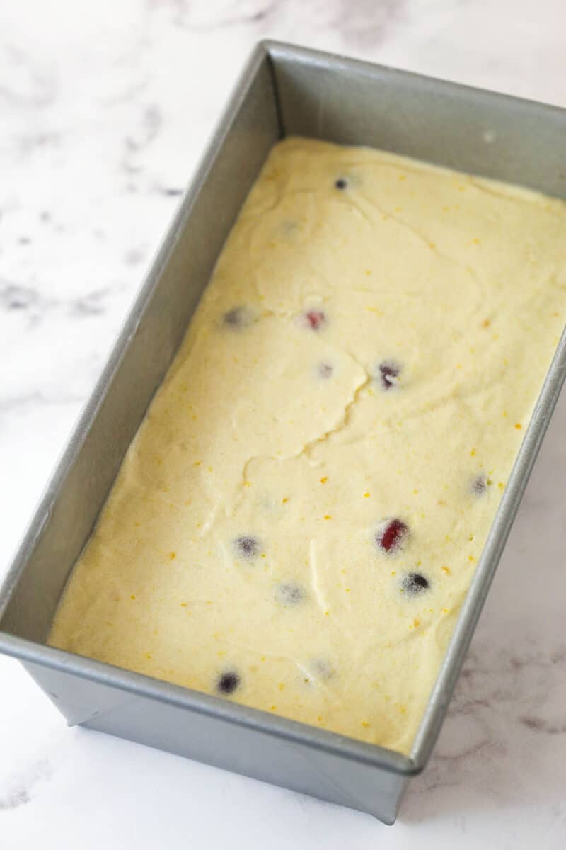 Orange cranberry batter in a baking pan.