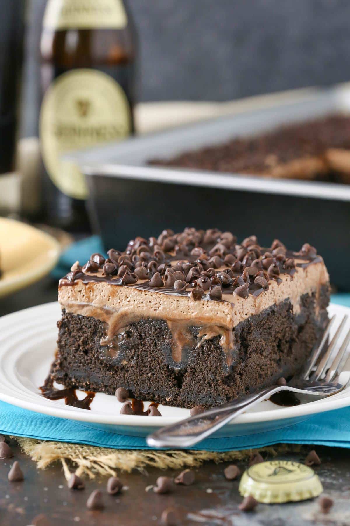 A slice of Guinness chocolate poke cake on a white plate.