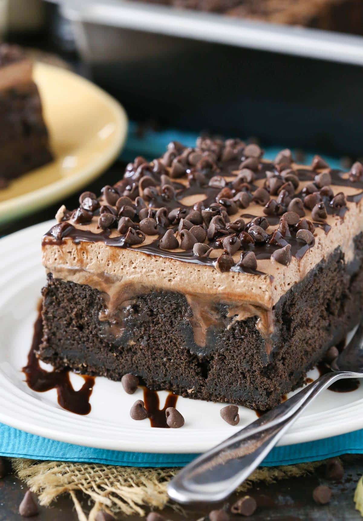 Close up of a slice of Guinness chocolate poke cake on a white plate.