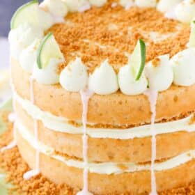 Close up of a key lime pie layer cake on a light green cake stand.