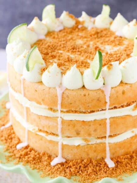 Close up of a key lime cake on a light green cake stand.