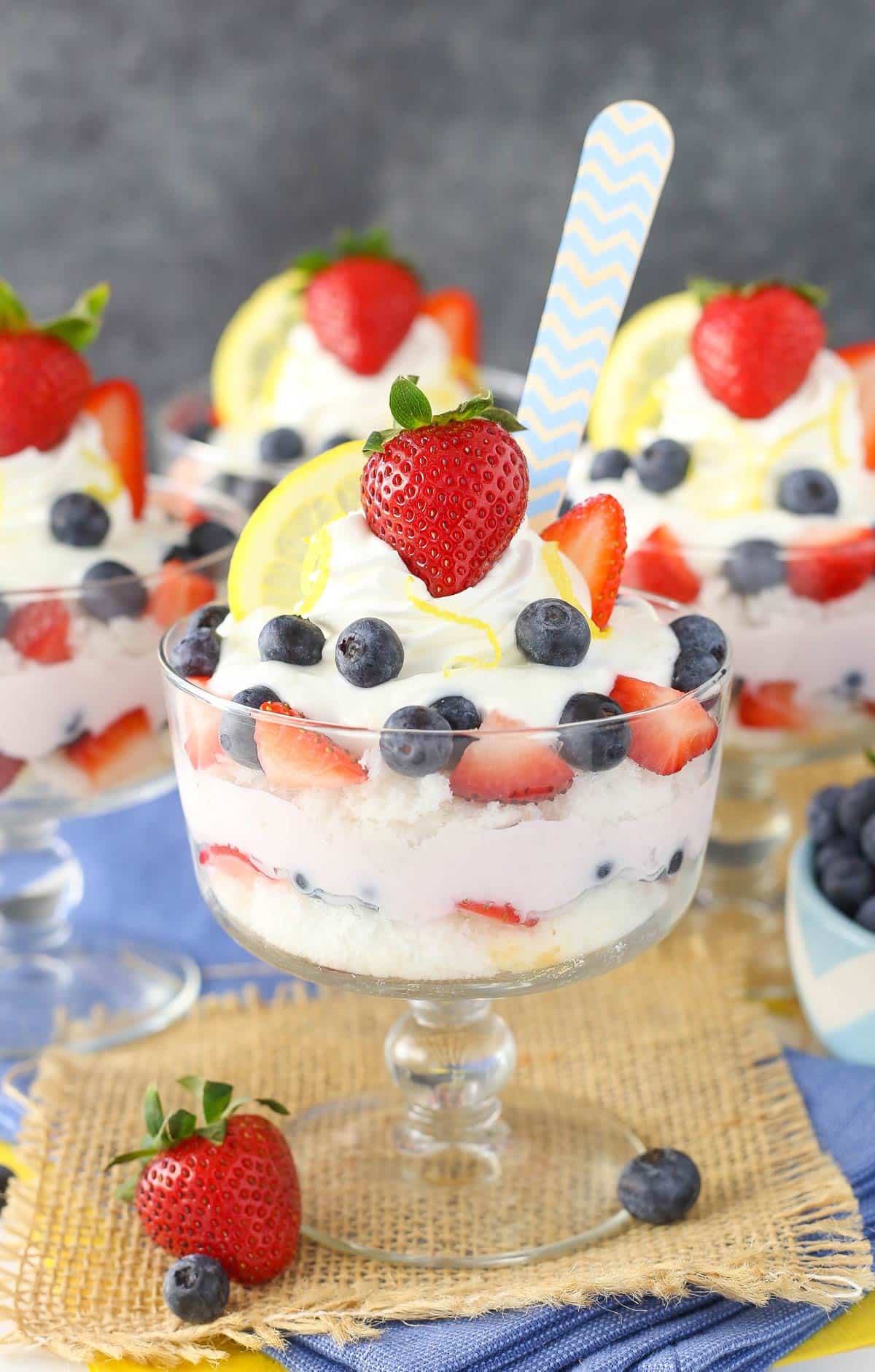 Close up of a lemon berry yogurt trifle with a spoon in it.