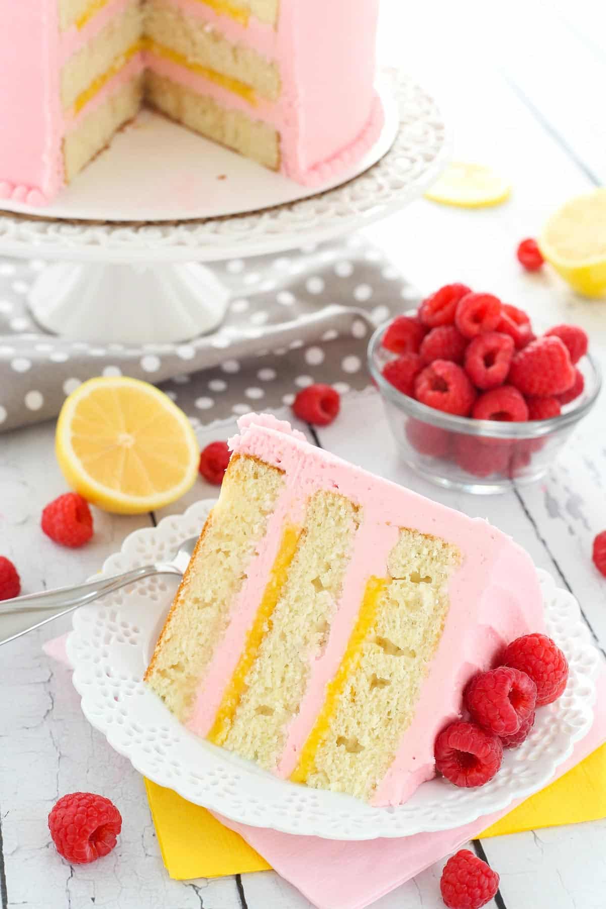 A slice of lemon raspberry cake on a small white plate.