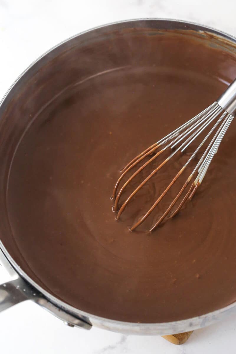 Whisking butter, chocolate, and vanilla into the pudding base for Mississippi mud pie.