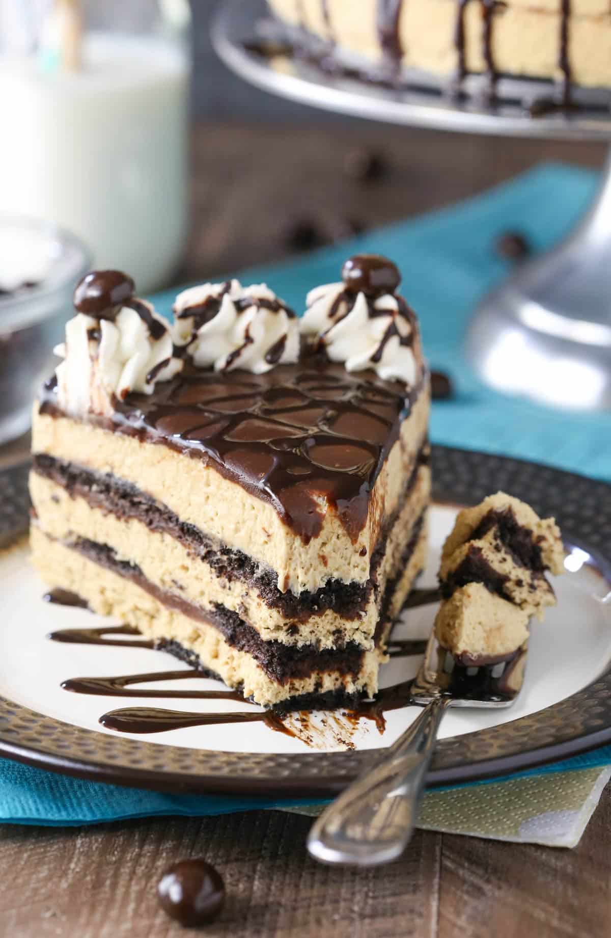 A slice of mocha chocolate icebox cake with a bite removed on a fork.