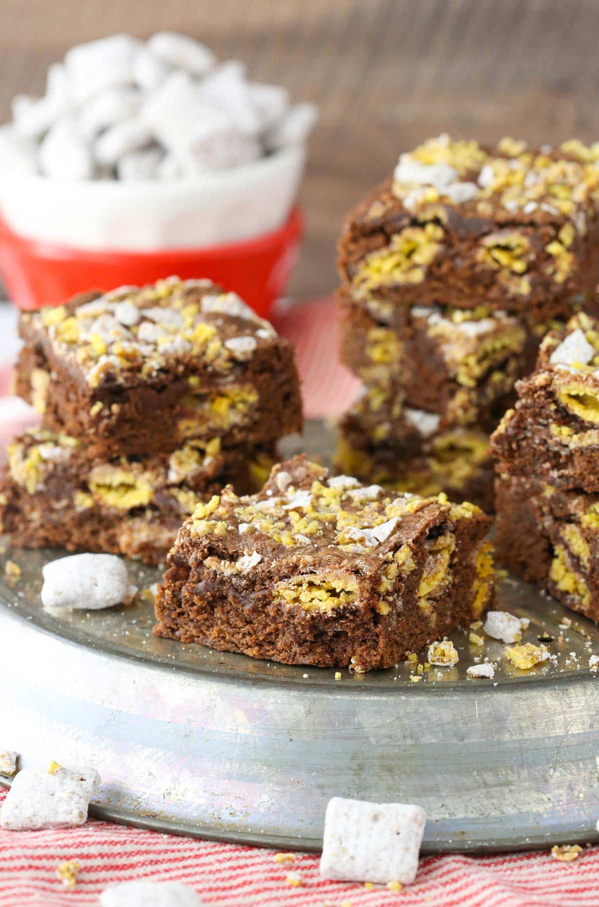 Several muddy buddy brownies on a silver tray.
