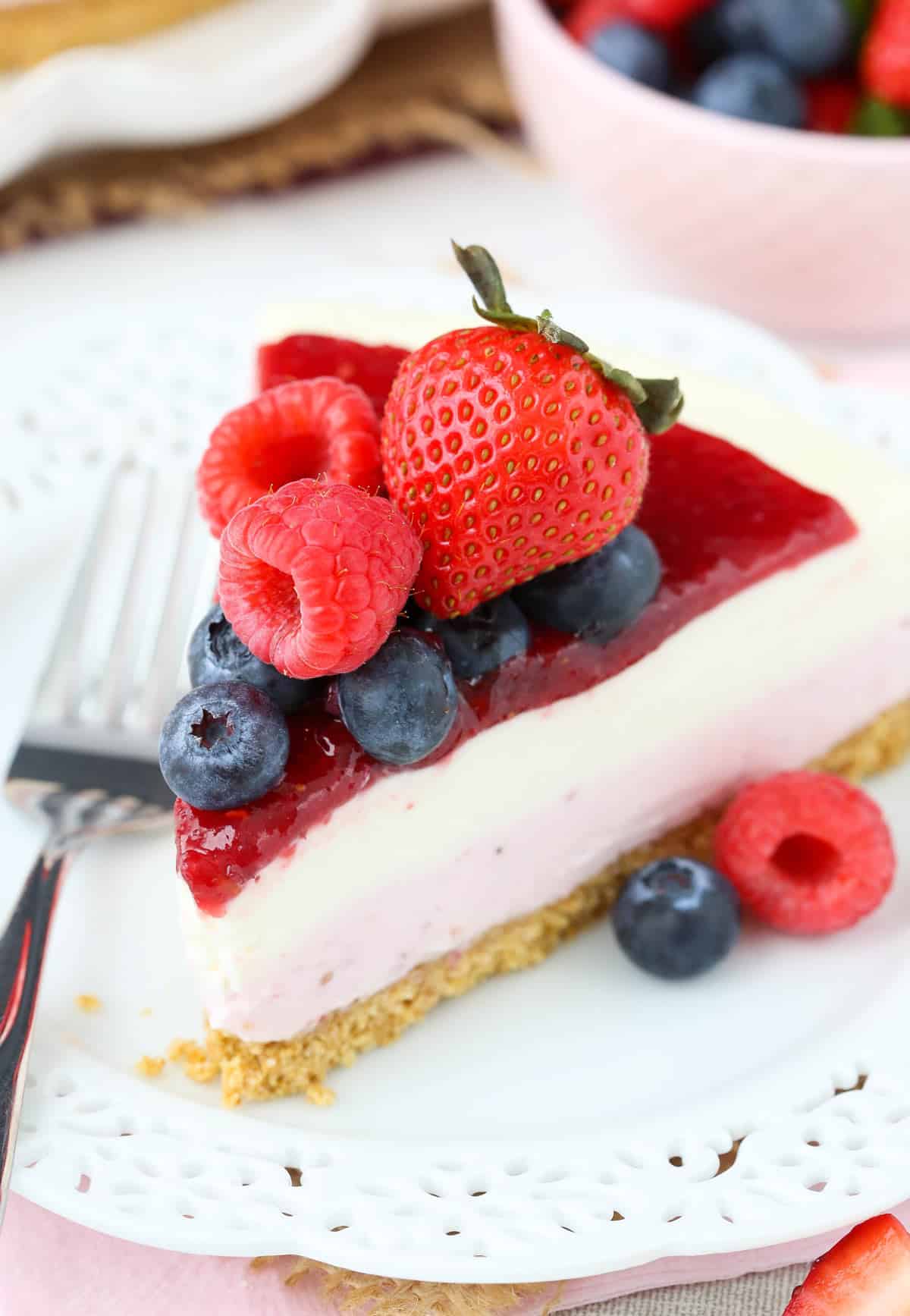 Close up of a slice of no bake berry vanilla cheesecake.