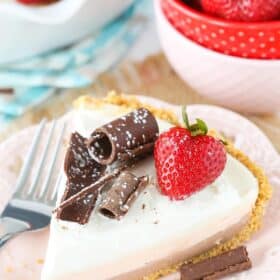 A slice of no bake neapolitan cheesecake pie on a white plate.