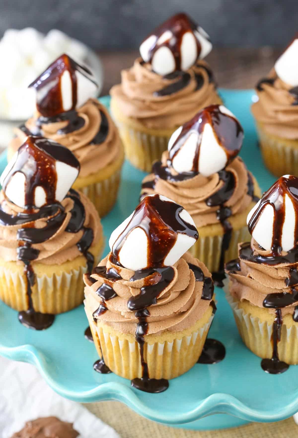 Overhead view of Nutella fluffernutter cupcakes on a blue cake stand.