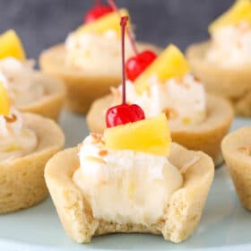 Close up of a pina colada cookie cup with a bite out of it.