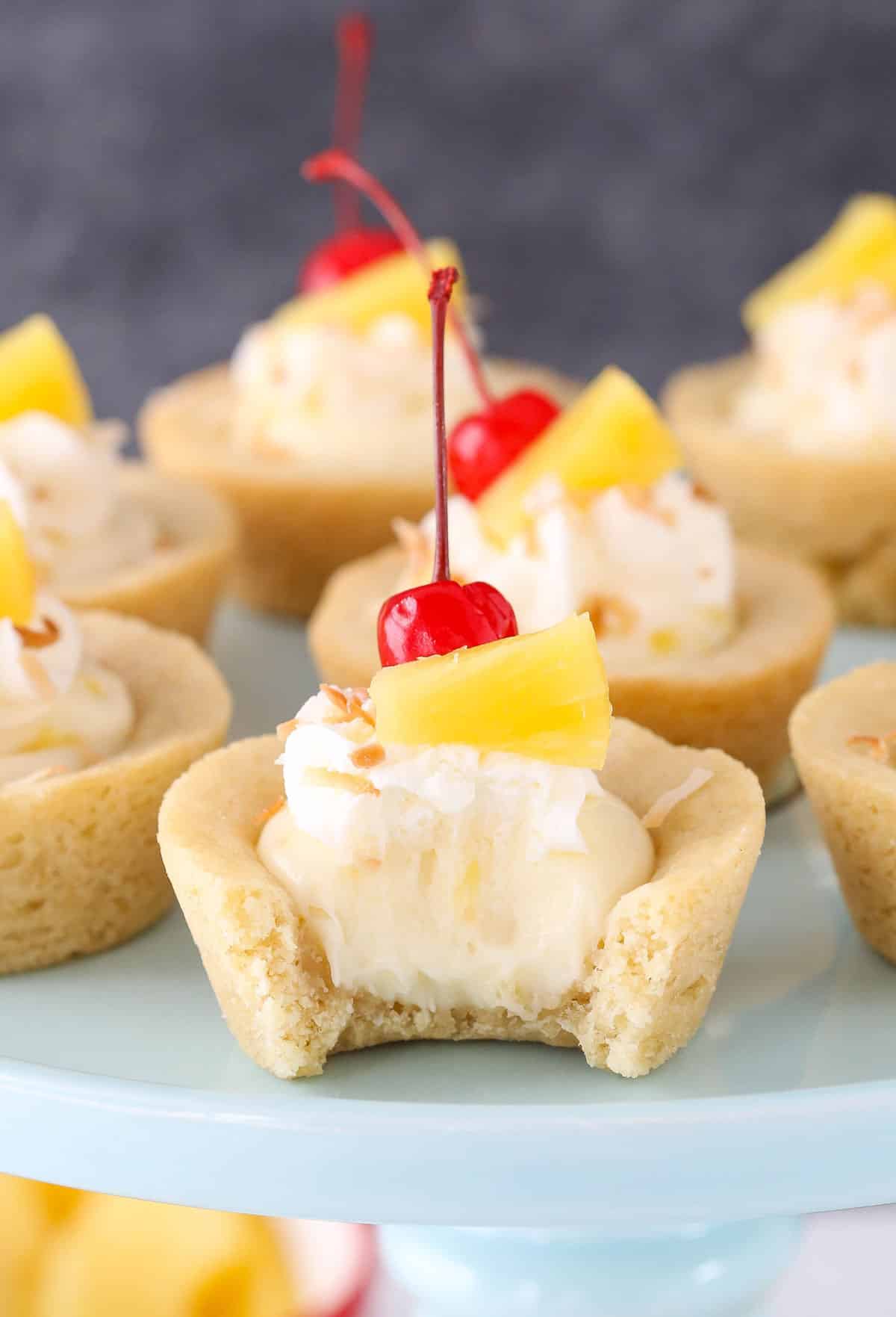Close up of a pina colada cookie cup with a bite out of it.
