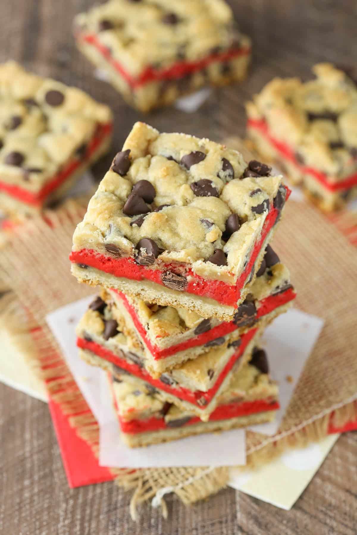 Top view of a stack of four red velvet cheesecake chocolate chip cookie bars.
