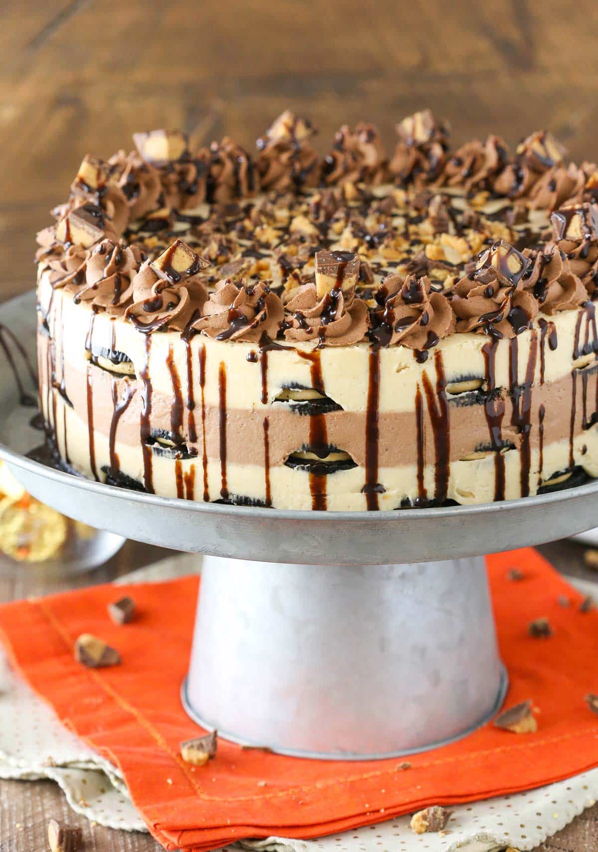 Close up of a Reese's peanut butter chocolate icebox cake on a silver cake stand.
