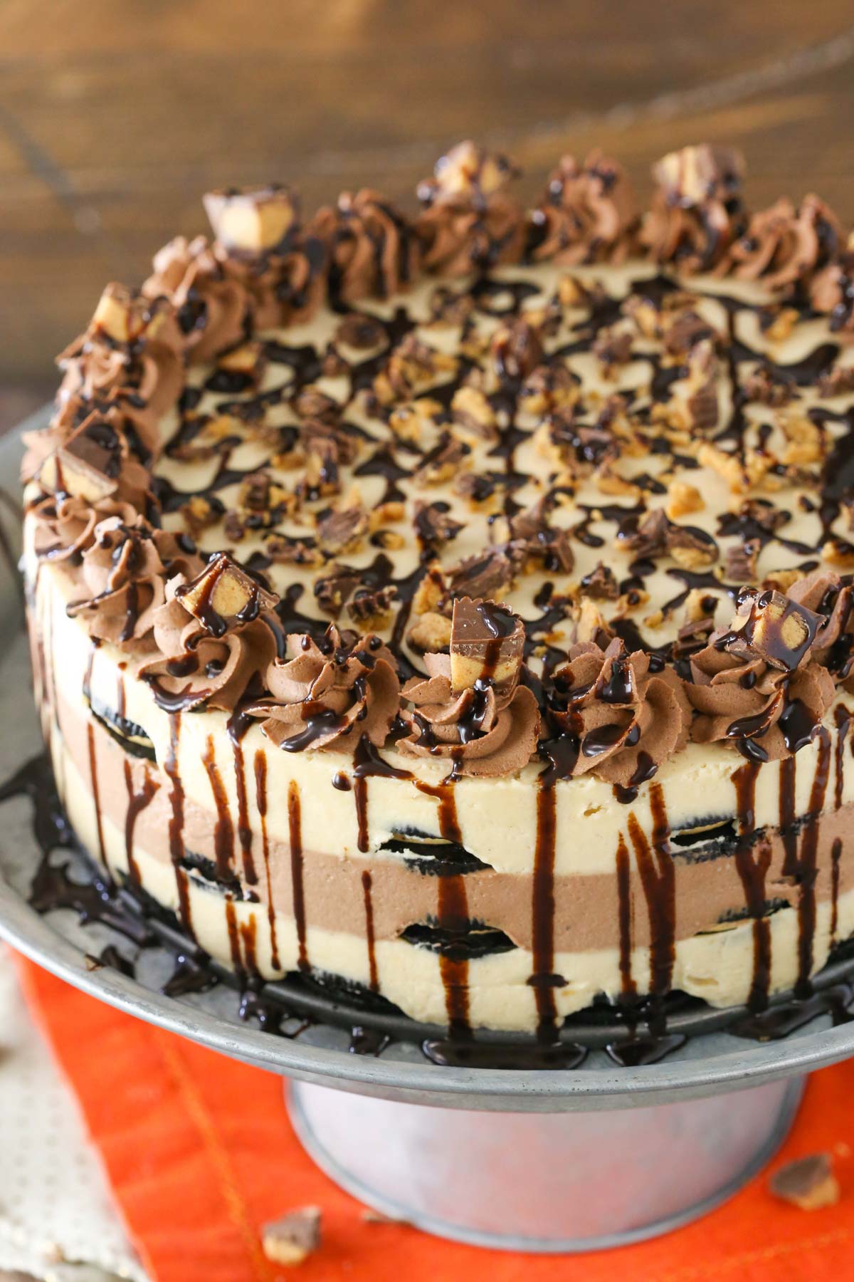 Close up of a Reese's peanut butter chocolate icebox cake on a silver cake stand.