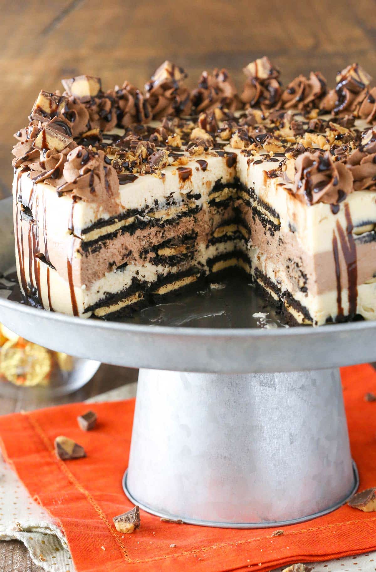 A Reese's peanut butter chocolate icebox cake with a slice removed to show layers.