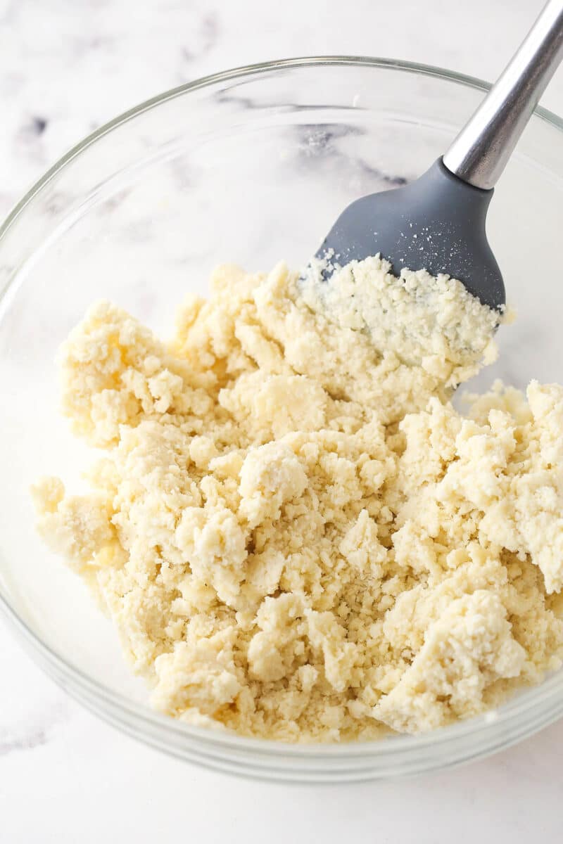 Add water to pie dough until it holds together.