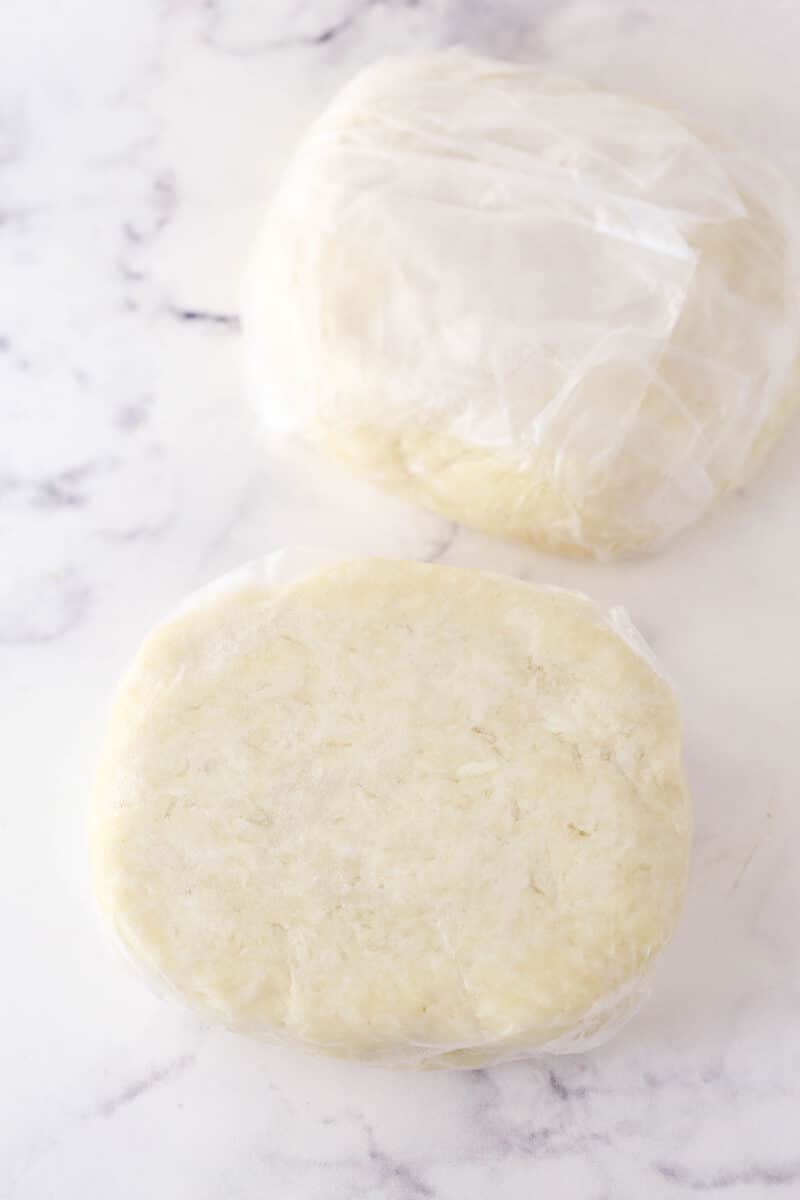 pie crust divided into two discs and wrapped in clear wrap