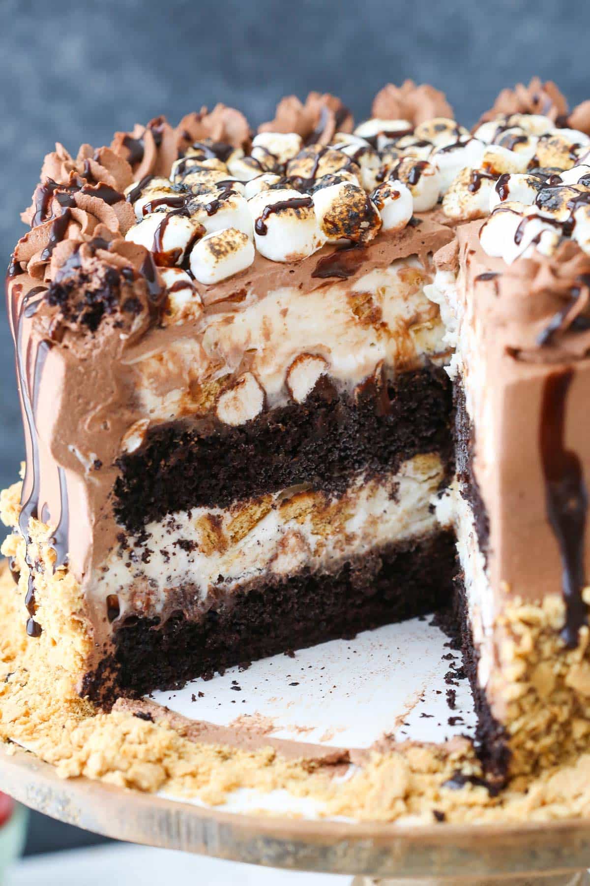 A s'mores ice cream cake with a slice removed to show internal layers.