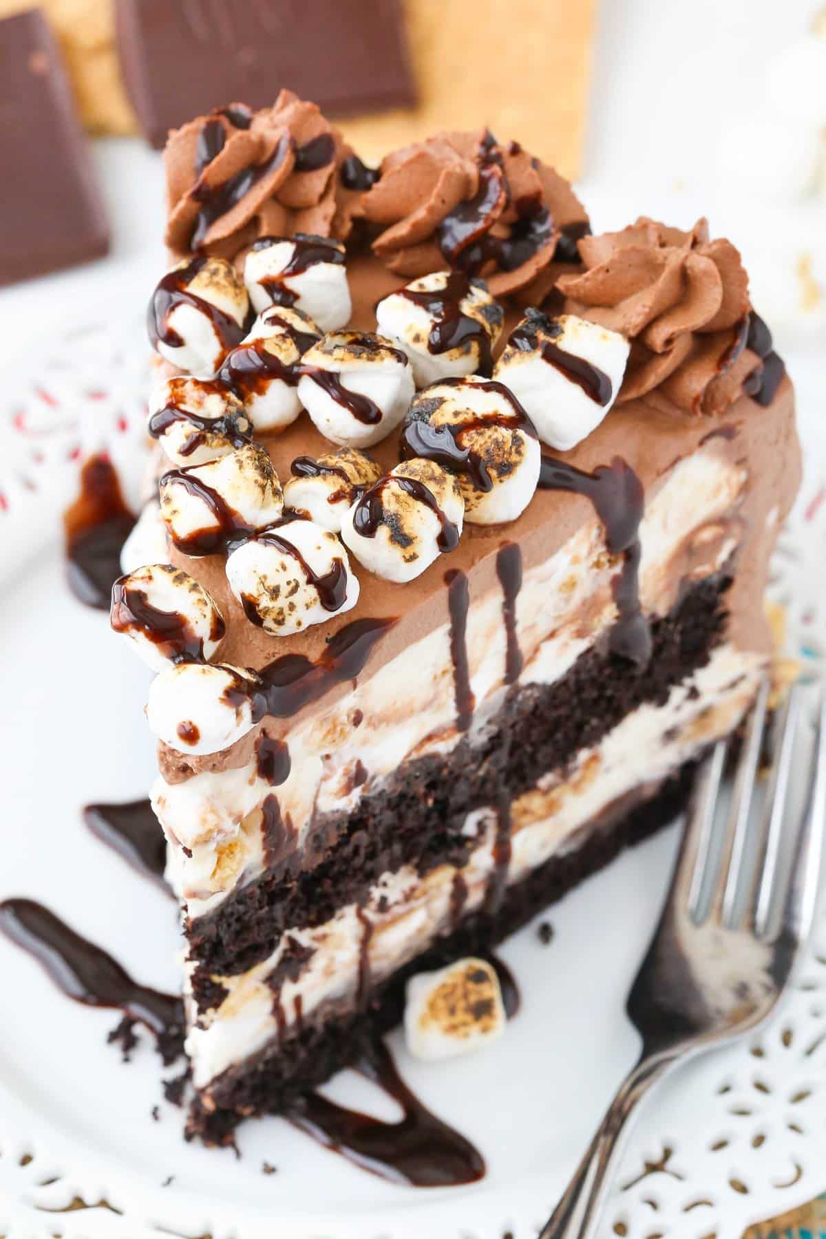 Close up of a slice of s'mores ice cream cake on a white plate.