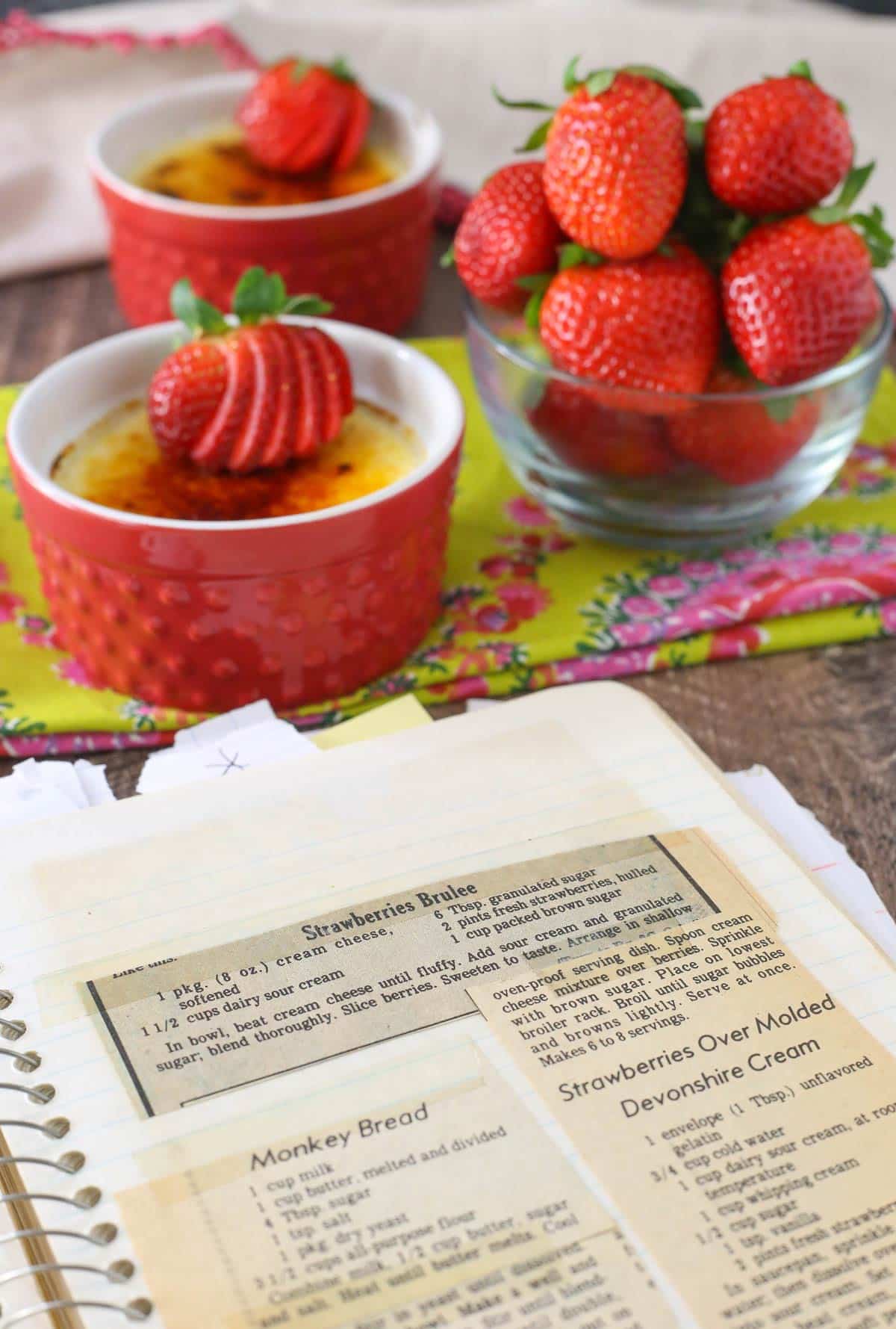 A notebook with the newspaper clipping recipe for strawberries brulee.