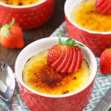 A red ramekin with strawberries brulee.