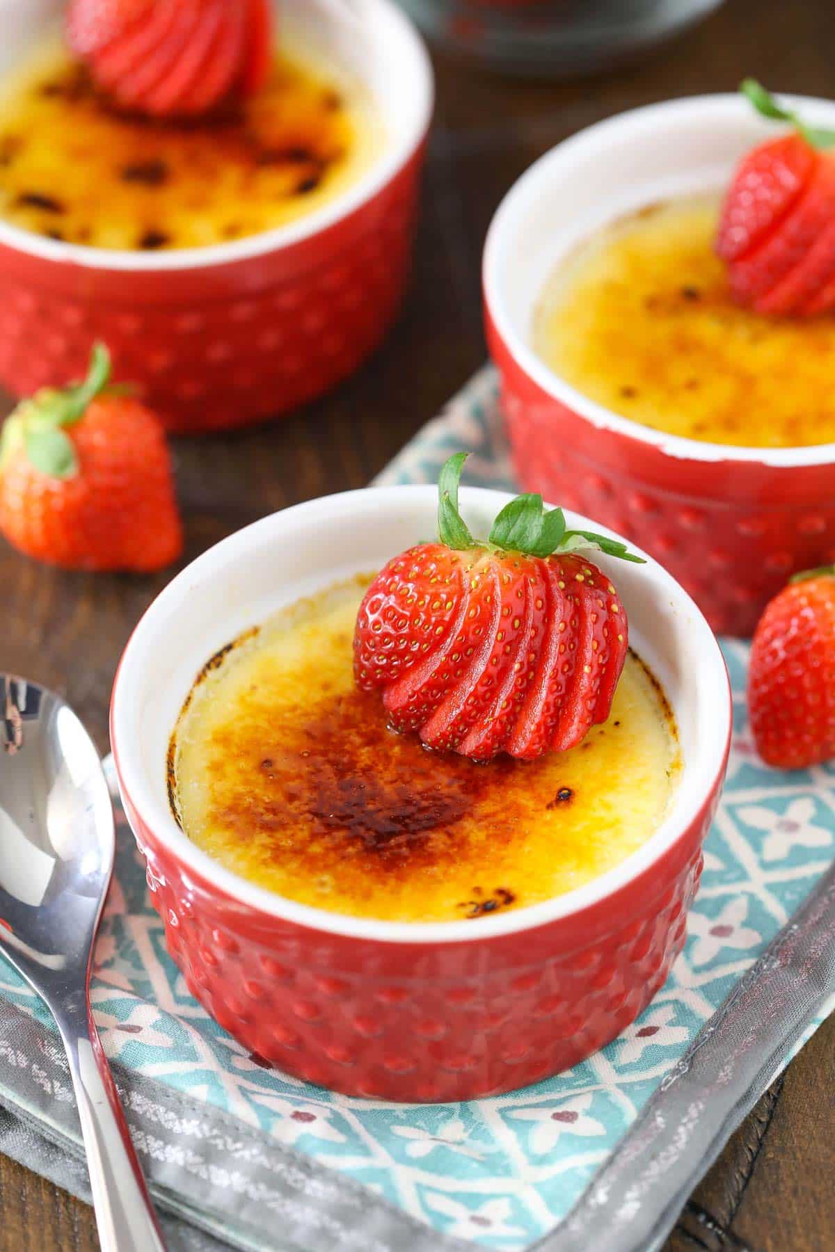 A red ramekin with strawberries brulee.