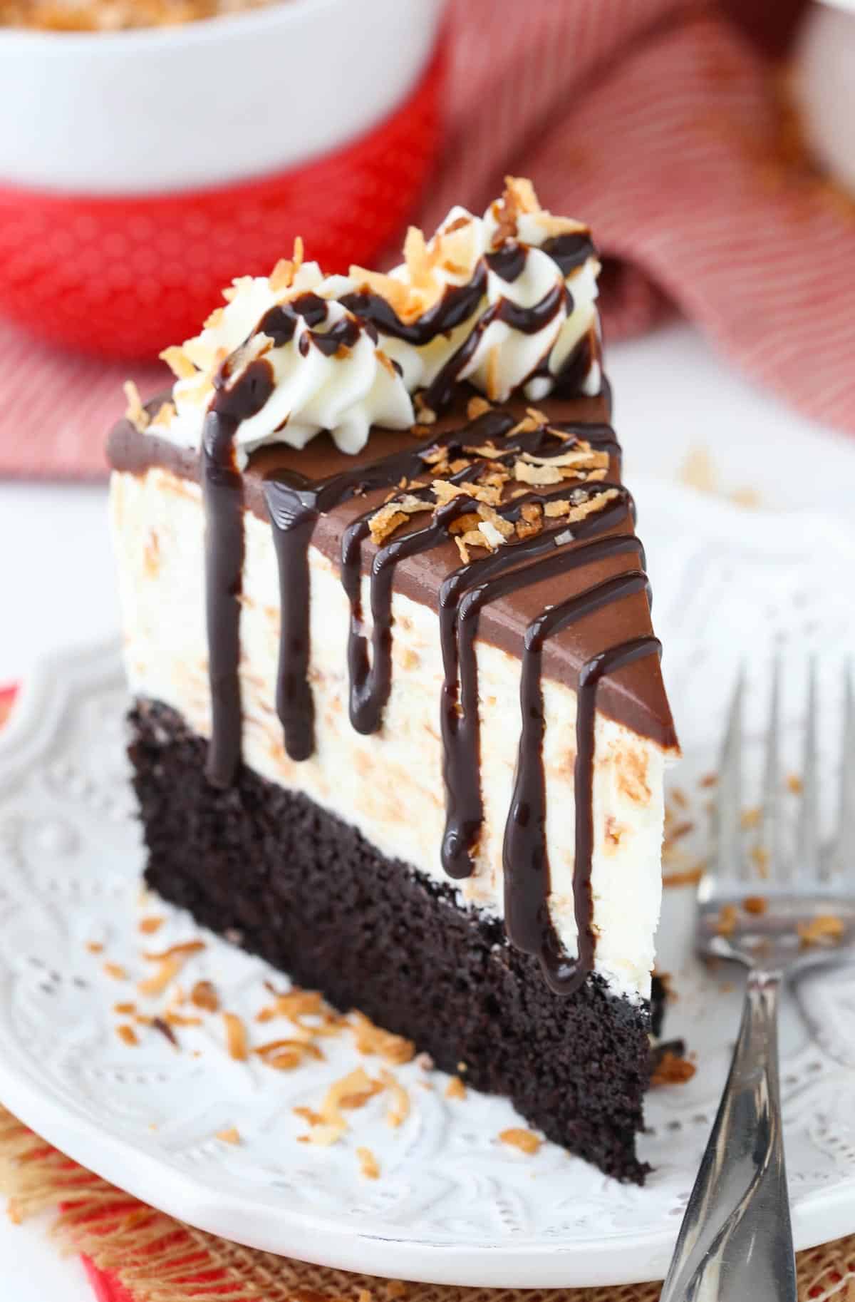 A slice of toasted coconut chocolate ice cream cake on a white plate.
