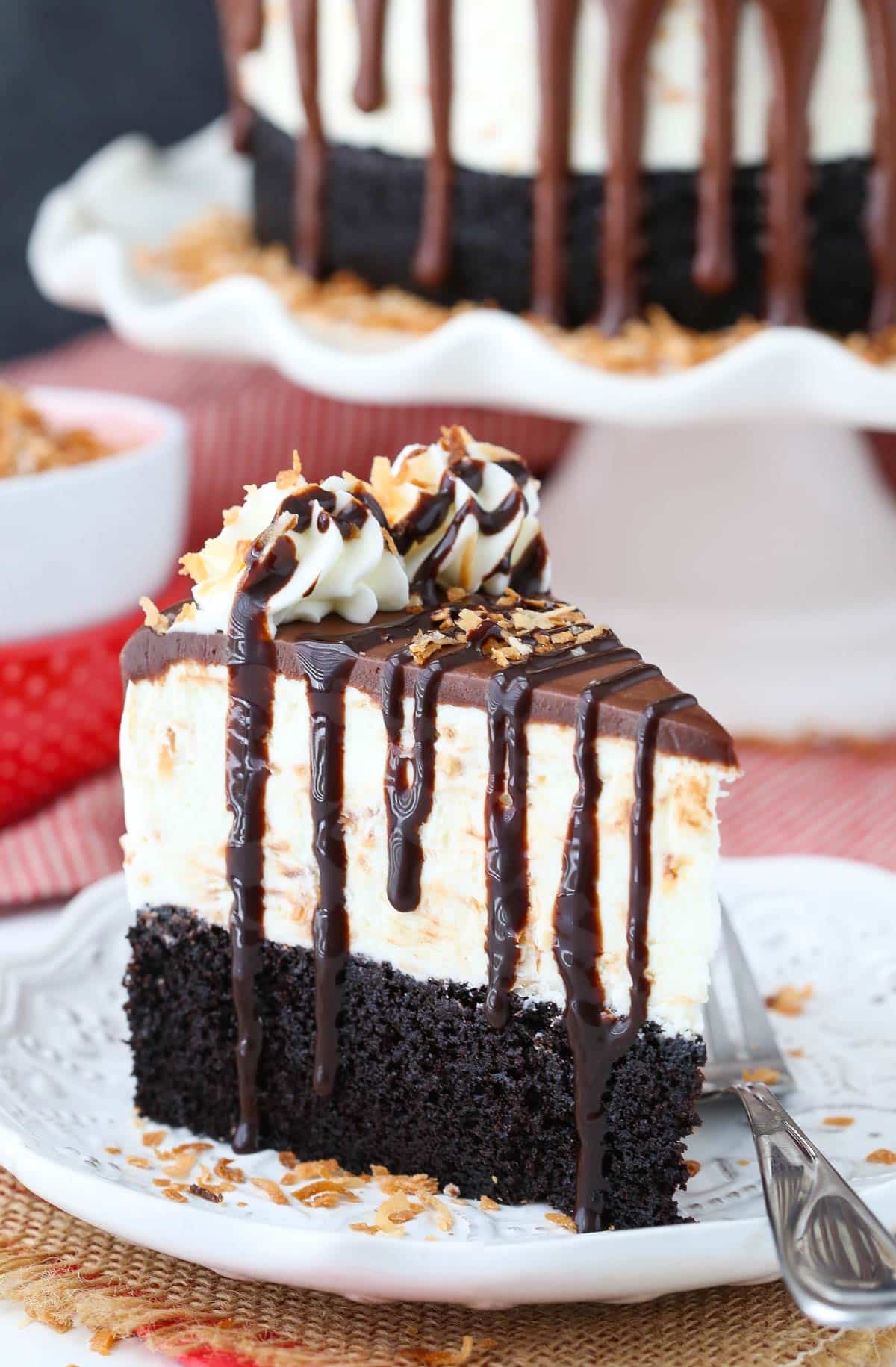 A slice of toasted coconut chocolate ice cream cake on a white plate.
