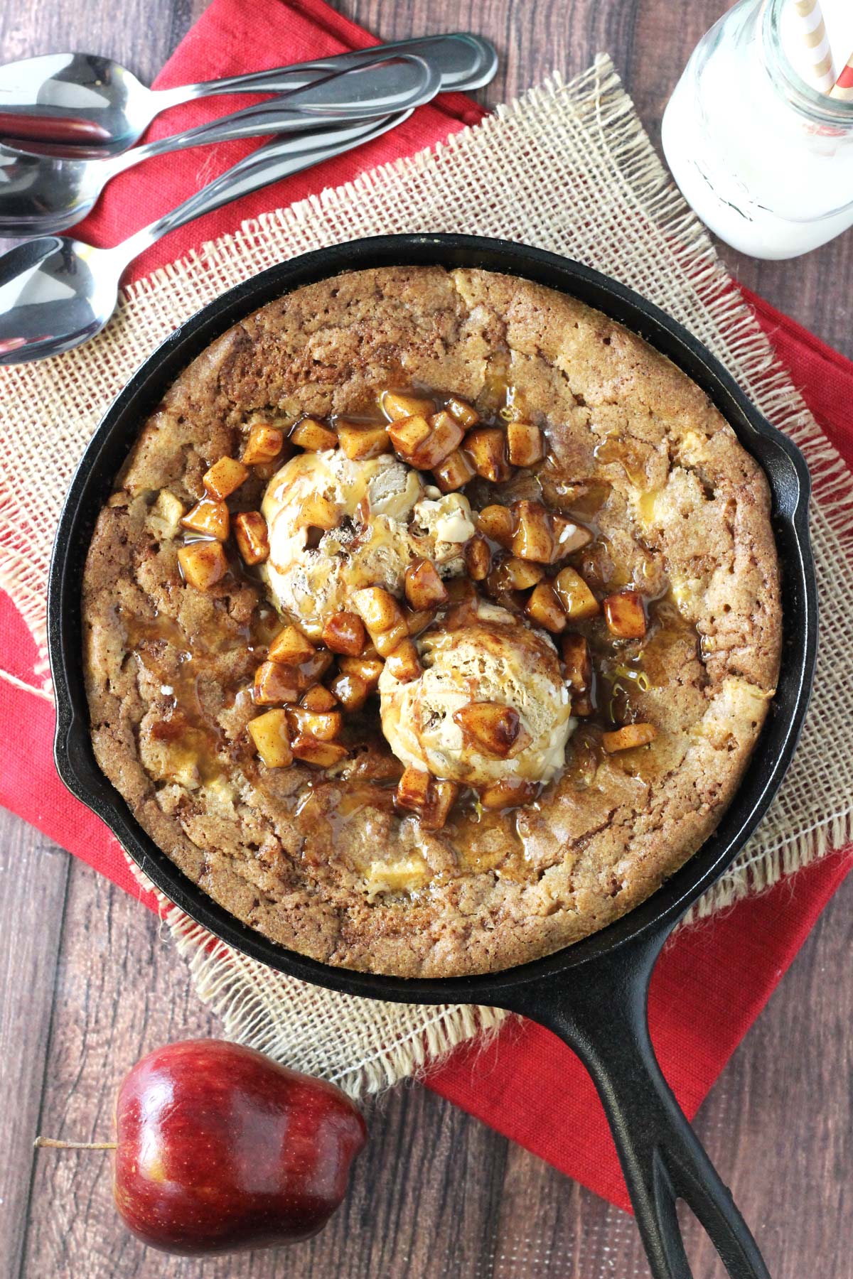 Top view of an apple cinnamon skillet blondie topped with ice cream and apples.