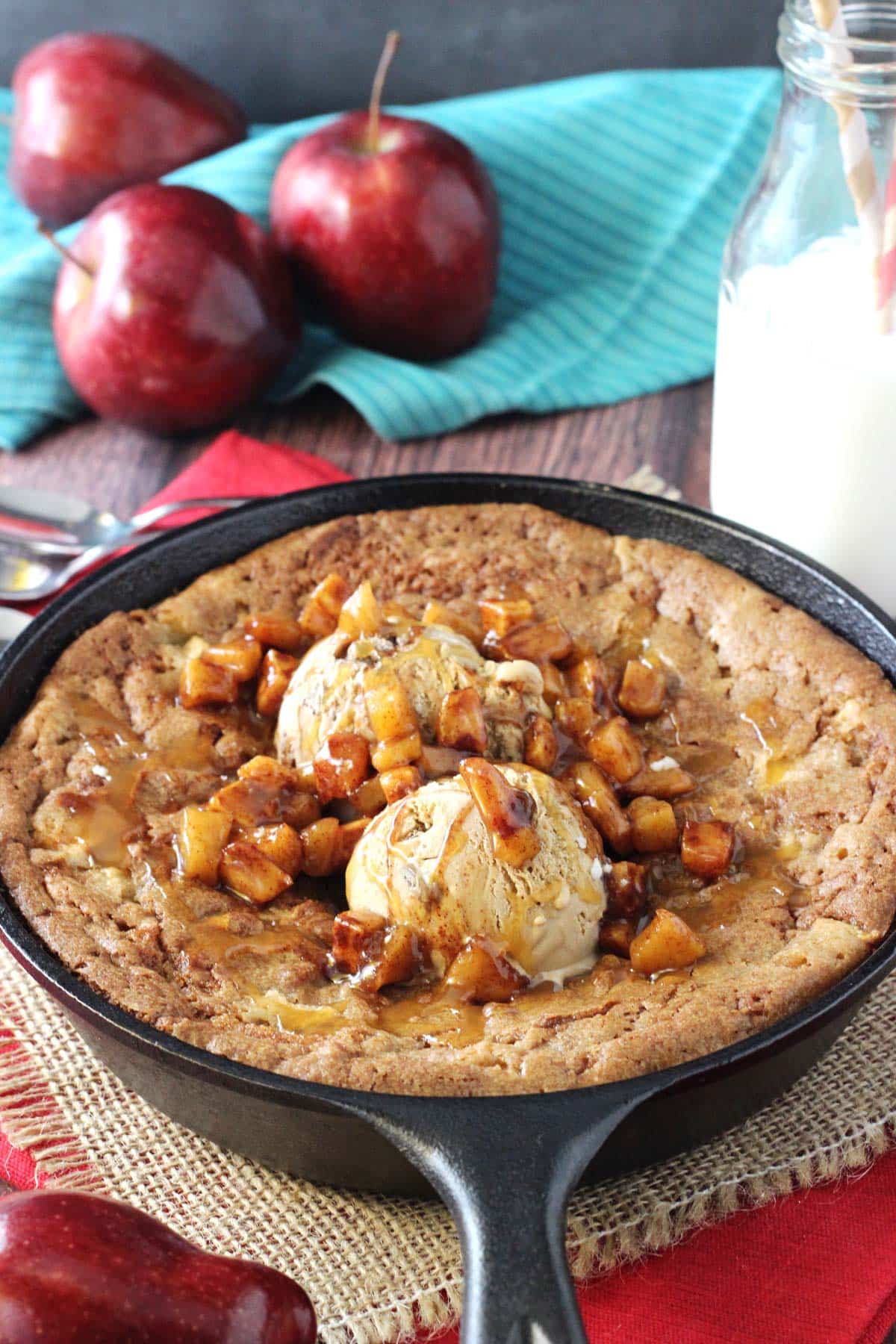 Close up of an apple cinnamon skillet blondie with ice cream and apples on top.