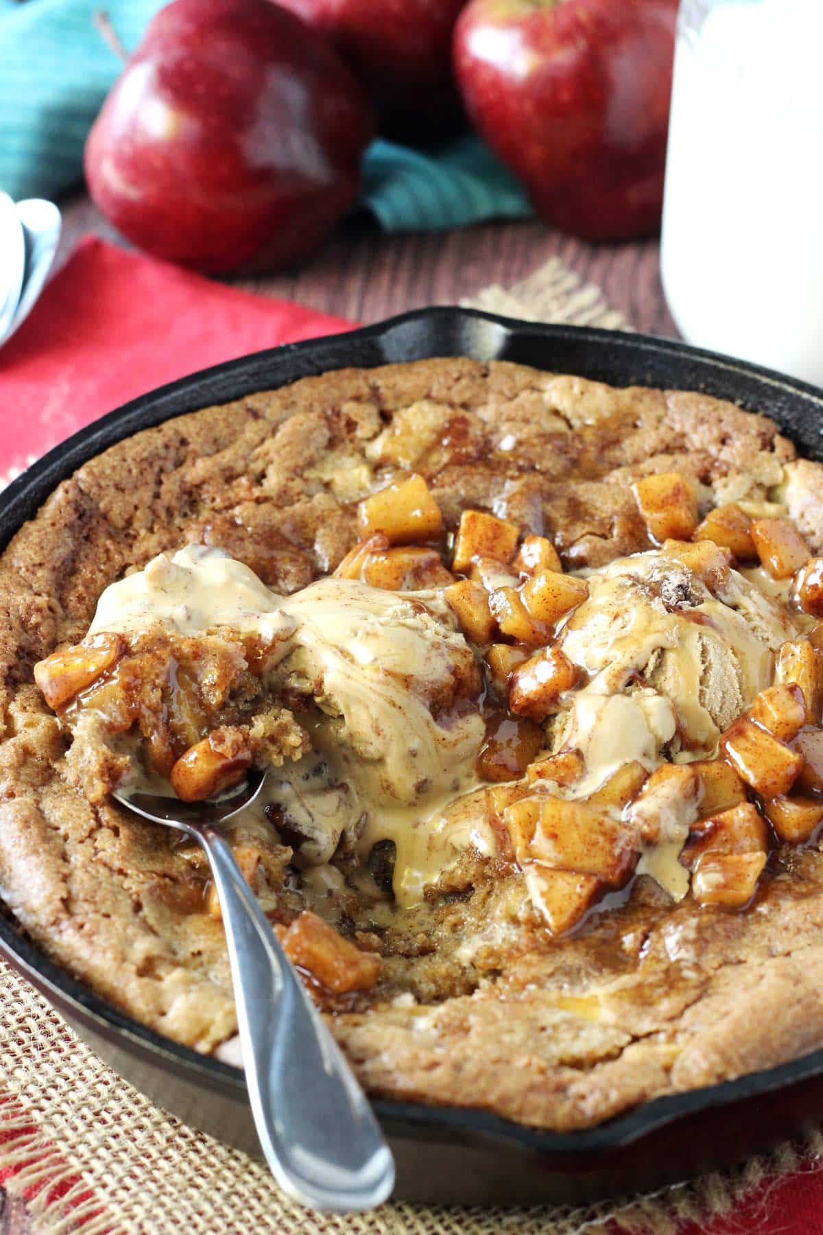 A spoon digging into an apple cinnamon skillet blondie.