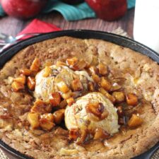 Close up of an apple cinnamon skillet blondie with ice cream and apples on top.
