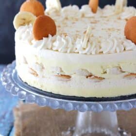 A banana pudding icebox cake on a glass cake stand.