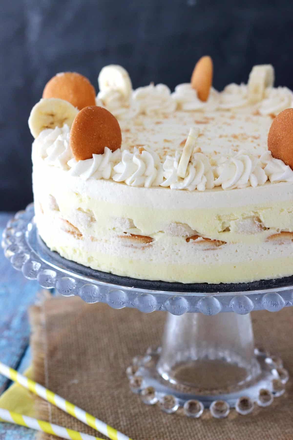 A banana pudding icebox cake on a glass cake stand.