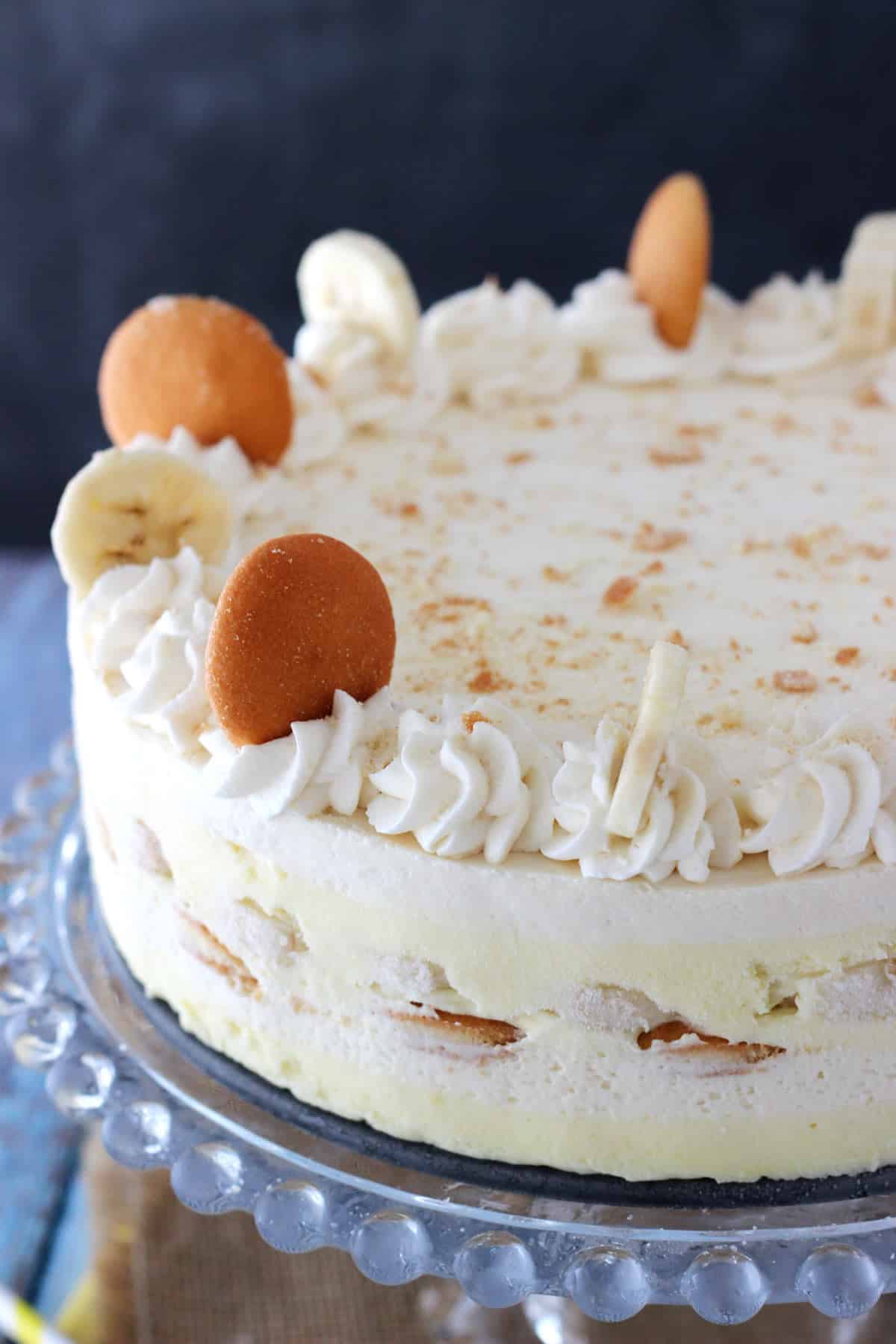 Close up of a banana pudding icebox cake on a glass cake stand.
