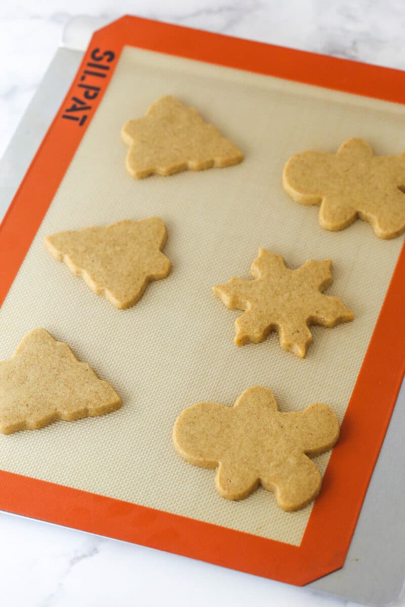 These brown sugar cutout cookies are the best! Browning the butter gives them a nutty, caramelized flavor and a dreamy, soft, chewy texture. Brown sugar cutout cookies on a baking sheet.